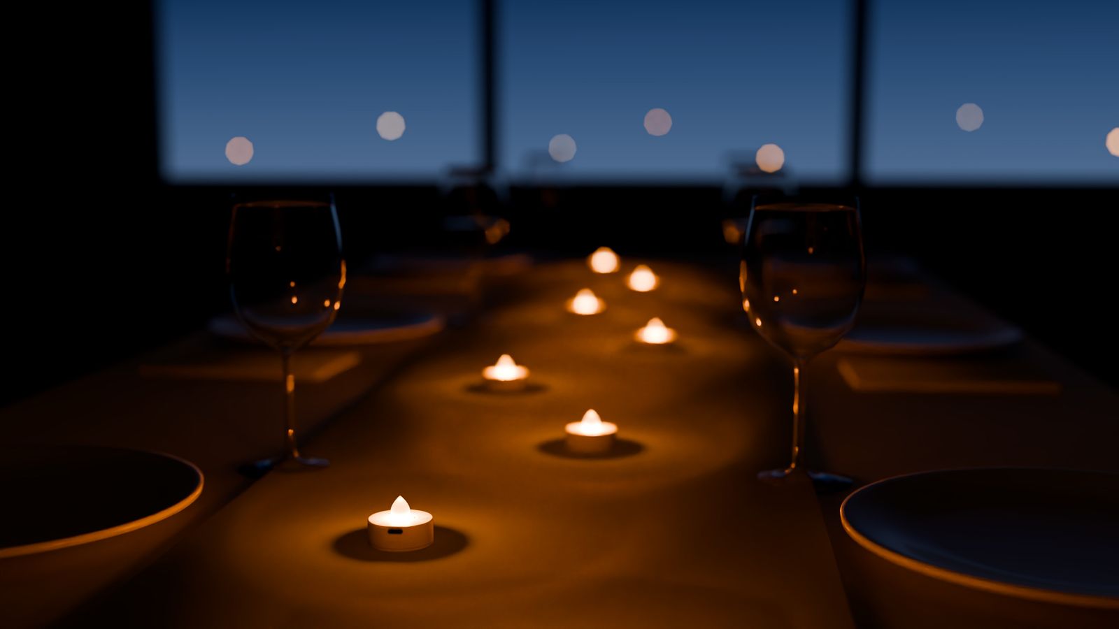 A dinner table at dusk with eight teelicht pro lights glowing along a linen runner, between plates and wine glasses.
